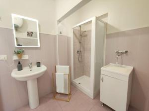 a bathroom with a sink and a shower and a toilet at siciliacasevacanze - Pola Home in Marina di Ragusa