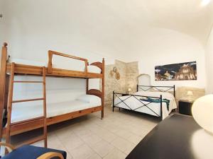 a bedroom with two bunk beds in a room at siciliacasevacanze - Pola Home in Marina di Ragusa