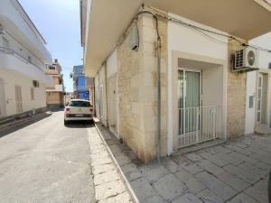 a car parked on a street next to a building at siciliacasevacanze - Pola Home in Marina di Ragusa