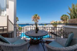 a balcony with a table and chairs and the ocean at Los Olivos 13 - One Bed in Adeje