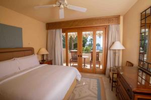 a bedroom with a bed and a desk and a balcony at Beautiful villa at Four Seasons in Sharm El Sheikh