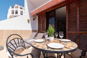 a patio with a table and chairs on a balcony at Park Santiago II 178 - Two Bed in Playa de las Americas