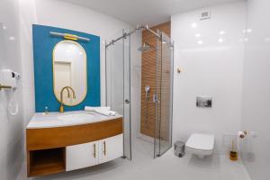 a bathroom with a sink and a shower with a mirror at SunRise Beach in Venus +76 photos