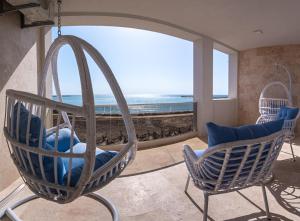 a room with two chairs and a swing at SunRise Beach in Venus