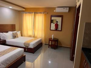 a hotel room with two beds and a mirror at Oakwood Guest House in Palatswe