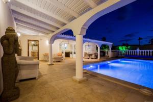 a large swimming pool in a living room with a ceiling at Villa Freesia with heated pool and air conditionin in San Miguel de Abona