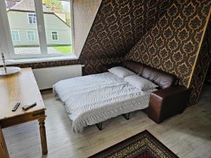 - une chambre avec un lit, une table et une fenêtre dans l'établissement Square apartments, à Rokiškis