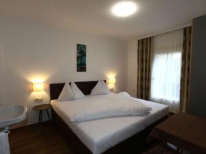 a bedroom with a white bed and a window at holiday home Bergheim F gen in Fügen