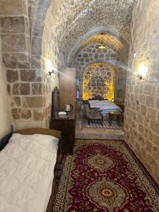 a bedroom with a bed in a stone room at Rumet paşa konağı in Mardin