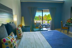 科爾瓦的住宿－Baywatch Resort, Colva Goa，一间带大床的卧室和一个阳台