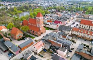 an aerial view of a town with a church at Slow River Apartment in Nowe Miasto Lubawskie