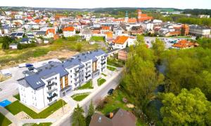 an overhead view of a city with a white building at Slow River Apartment in Nowe Miasto Lubawskie