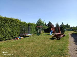 a park with two picnic tables and a playground at Przystań w Jezierzanach in Jezierzany