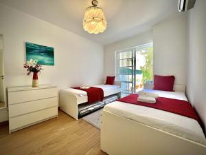 Un dormitorio con dos camas y una ventana. en Vilamoura Eden Villa With Pool by Homing, en Vilamoura 20 fotos más