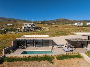 an aerial view of a house with a swimming pool at 'S CAVE VILLAS SEASIDE KARYSTOS in Karistos
