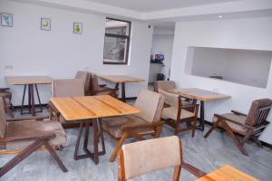 una clase con mesas y sillas y una pared blanca en Humphreys HillHouse, en Kisii