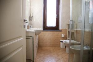 a bathroom with a toilet and a sink at Lucca Mira in Lucca +16 photos