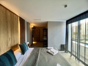 a bedroom with a large bed and a large window at Boutique Palacio in Alicante