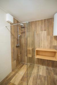 a bathroom with a shower with a glass door at Rogla Alpina Residence in Zreče