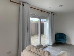 a living room with a couch and a sliding glass door at Bee-Hive Corner in Southampton
