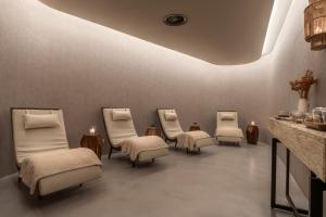 a waiting room with four chairs and a table at Immerso Hotel, a Member of Design Hotels in Ericeira