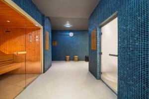 a bathroom with blue tiled walls and a shower at Immerso Hotel, a Member of Design Hotels in Ericeira