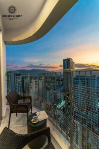 a balcony with chairs and a view of a city at Best View Panorama Suites managed by MLB in Nha Trang