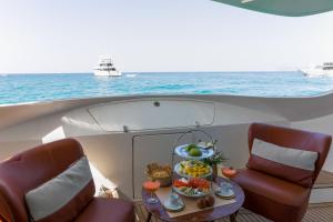 a table with a tray of food on a boat at House of Hütter- Floating Home Goldfinger in Ibiza Town