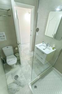 a bathroom with a toilet and a sink and a shower at Los Huertos de Nerja 6 in Nerja