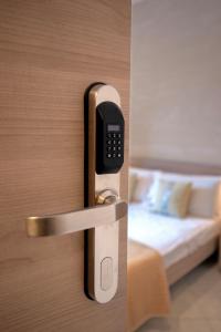 a door with a cell phone in a room with a bed at Casa Vacanze Carolina 348 in Naples