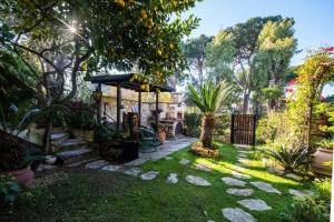 a garden with a gazebo in a yard at Charming elegant home in Casalpalocco, Roma ***** in Casal Palocco