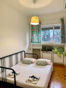 a bedroom with a bed in a room with a window at Charming elegant home in Casalpalocco, Roma ***** in Casal Palocco