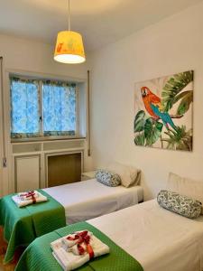 a room with two beds and a window at Charming elegant home in Casalpalocco, Roma ***** in Casal Palocco