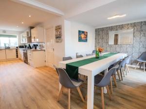 a kitchen and dining room with a table and chairs at THE Beach House in Prestatyn