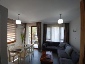 a living room with a couch and a table at Kordon YALI Suites in Fethiye +10 photos