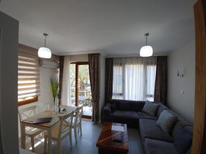 a living room with a couch and a table at Fethiye YALI SUITES in Fethiye