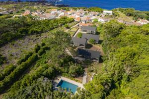 una vista aérea de una casa en una colina con piscina en Casas do Morgadio, en Biscoitos