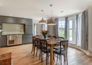 a kitchen and dining room with a table and chairs at Valley House in Cley next the Sea