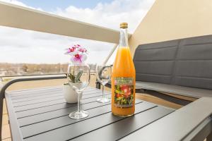 a bottle of wine and two glasses on a table at Héliopolis Naturist Luxury in Cap d'Agde +14 photos