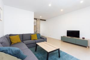 a living room with a couch and a tv at Home2Book Pleasant & Design Apt Santa Cruz Center in Santa Cruz de Tenerife