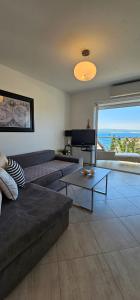 a living room with a couch and a table at Apartman Doris in Dramalj