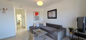a living room with a couch and a tv at Apartman Doris in Dramalj