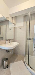 a bathroom with a sink and a shower at Apartman Doris in Dramalj +8 photos