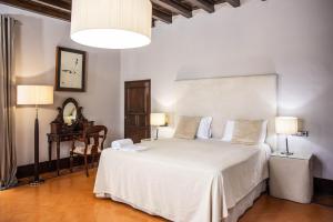 a bedroom with a large white bed and two lamps at RVHotels Palau Lo Mirador in Torroella de Montgrí +37 photos