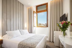 a hotel room with a bed and a window at Bella Venezia in Corfu Town