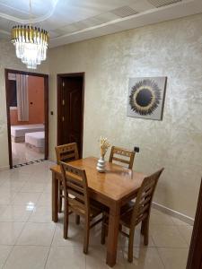 - une salle à manger avec une table et des chaises en bois dans l'établissement Luxury Modern Apartment, à Béni Mellal
