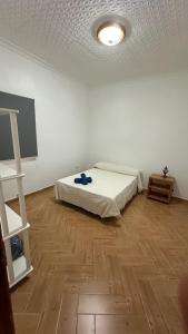 a bedroom with a bed and a wooden floor at Casa Rozita in Granadilla de Abona