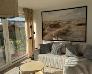 a living room with a couch and a table at Weststrandhaus in Großenbrode