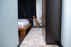 a bedroom with a bed and a chair in a room at Veda Royal Suite in Duzce