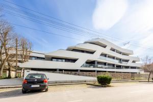a car parked in front of a building at Marina Apartman Balatonszemes by BLTN in Balatonszemes